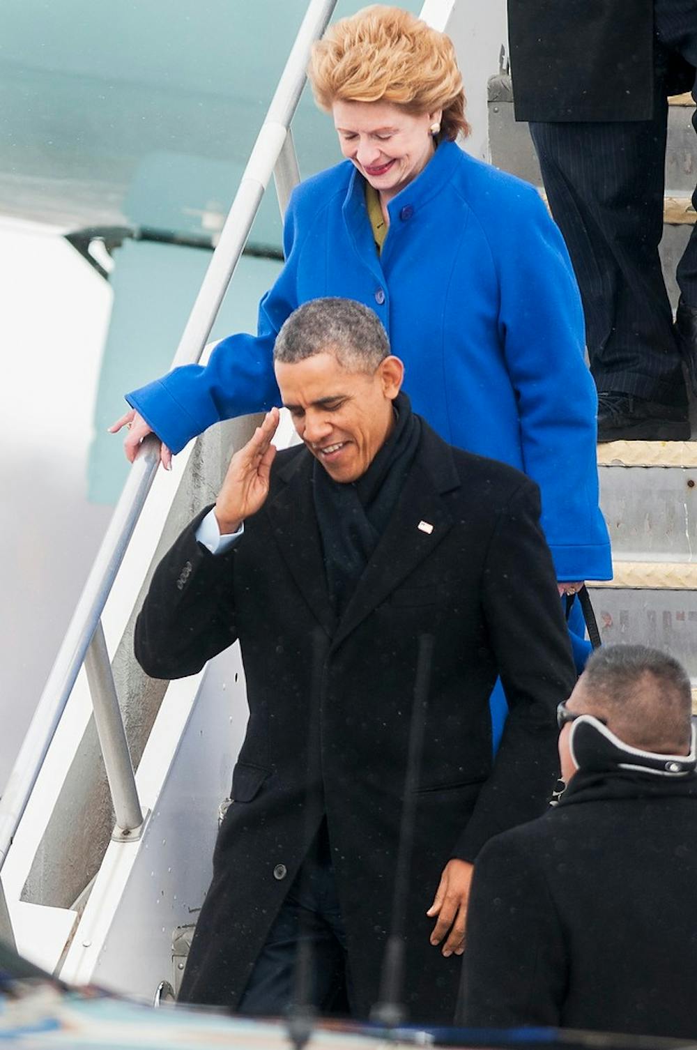 	<p>President Barack Obama salutes as he steps off of Air Force One on Friday at Capital Region International Airport in Lansing, followed by U.S. Sen. Debbie Stabenow, D-Mich. The president will be signing the farm bill on <span class="caps">MSU</span>&#8217;s campus later in the day. Danyelle Morrow/The State News</p>