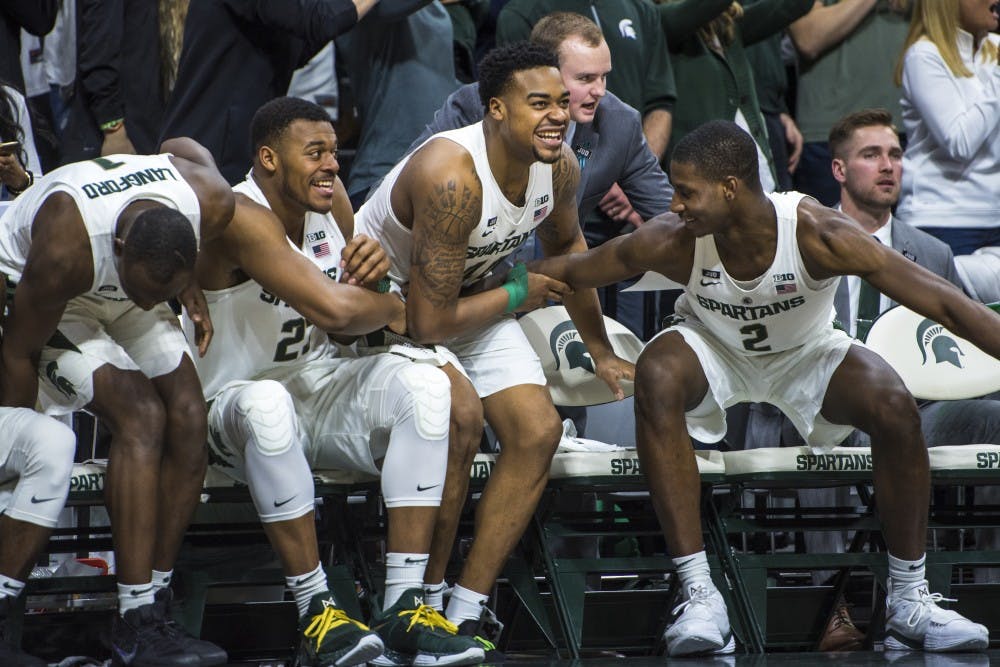 Freshman forward Xavier Tillman (23), sophomore forward Nick Ward (44) and freshman forward Jaren Jackson Jr. (2) celebrate during the second half of the men's basketball game against Purdue on Feb. 10, 2018 at Breslin Center. The Spartans defeated the Boilermakers, 68-65. (Nic Antaya | The State News)