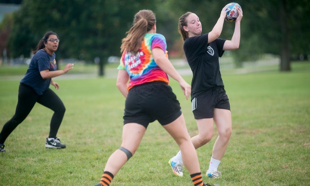 <p>Psychology freshman Brenna Myers makes a catch during a rugby practice on Sept. 28, 2015, at the Service Road fields. "It's a great way to get active," Myers said.</p>