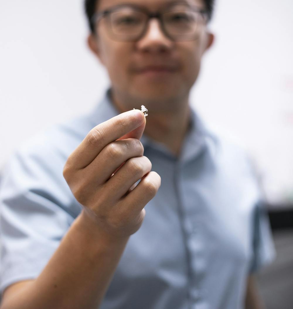 Biomedical engineering professor Jinxing Li holds a 3D-printed miniature flying robot on Sept. 21, 2022.