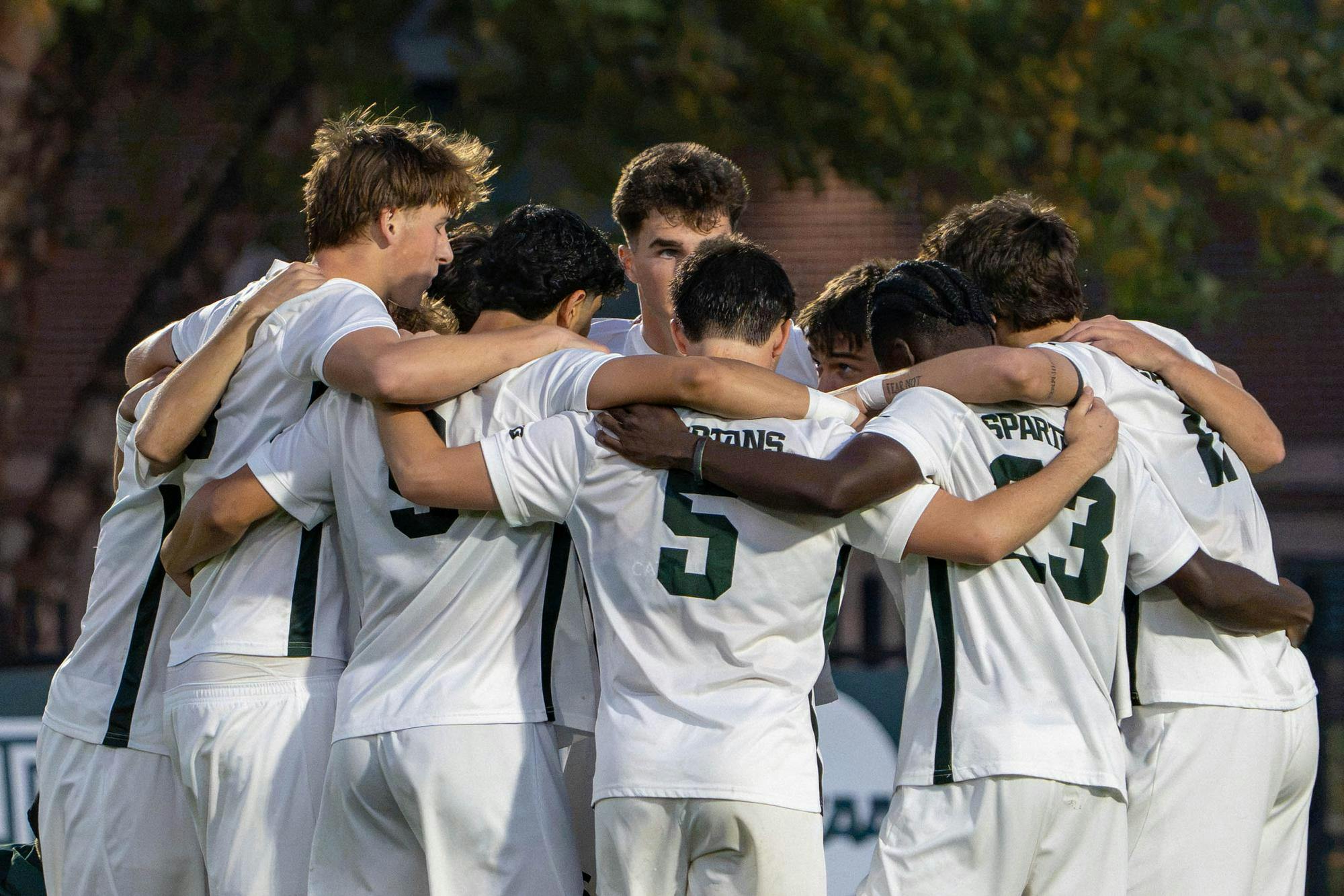 <p>Michigan State's starting lineup huddles together at midfield ahead of the second half of their game against Michigan at DeMartin Stadium in East Lansing, Mich., on Tuesday, Oct. 13, 2026.</p>