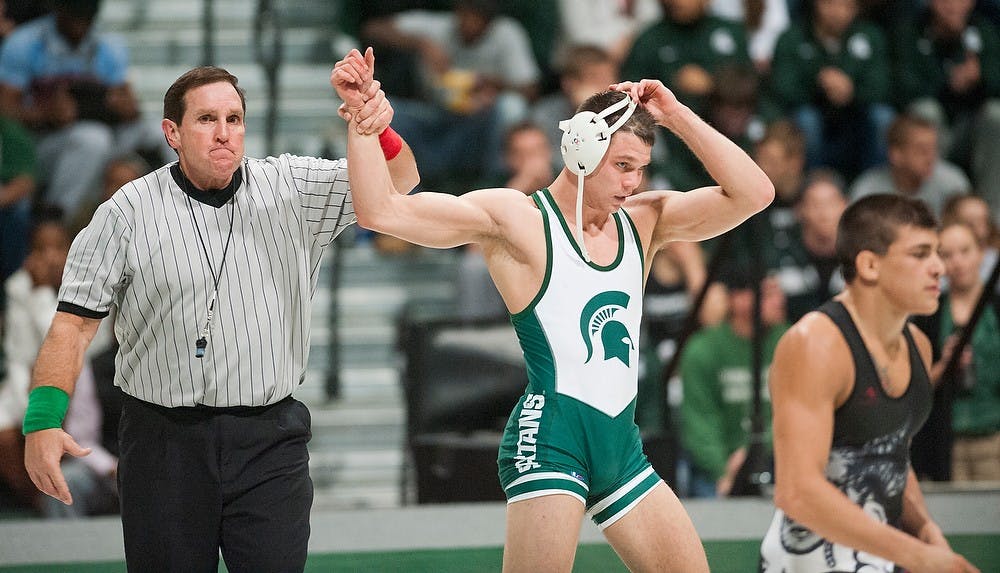 	<p>Game official declares senior David Cheza the victor of the 157-pound class match against Edinboro&#8217;s Michael DePalma, far right. Edinboro defeated <span class="caps">MSU</span>, 22-12, Friday, Nov. 30, 2012, at Jenison Field House. Justin Wan/The State News</p>