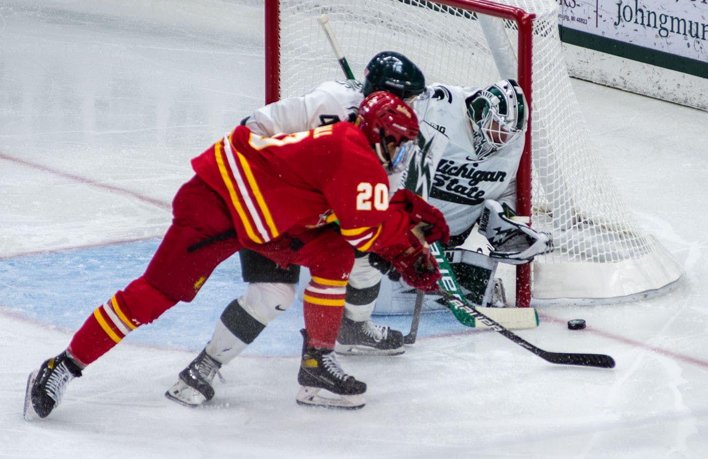<p>Senior goaltender Drew DeRidder (1) and sophomore right defense Nash Nienhuis (4) prevent a Ferris State shot on goal from going in during the second period. The Spartans beat the Bulldogs, 2-0, in the final minutes of the game on Nov. 11, 2021. </p>