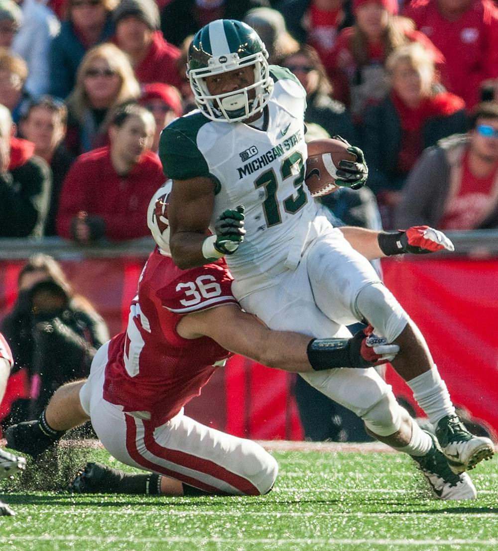 Junior wide receiver Bennie Fowler runs with the ball after making one of his six receptions on the day, as he is being dragged down by Wisconsin linebacker Ethan Armstrong, No. 36, and defensive back Dezmen Southward, No. 12. Michigan State defeated Wisconsin in overtime, 16-13, on Saturday afternoon, Oct. 27, 2012, at Camp Randall Stadium in Madison, Wisc. Justin Wan/The State News