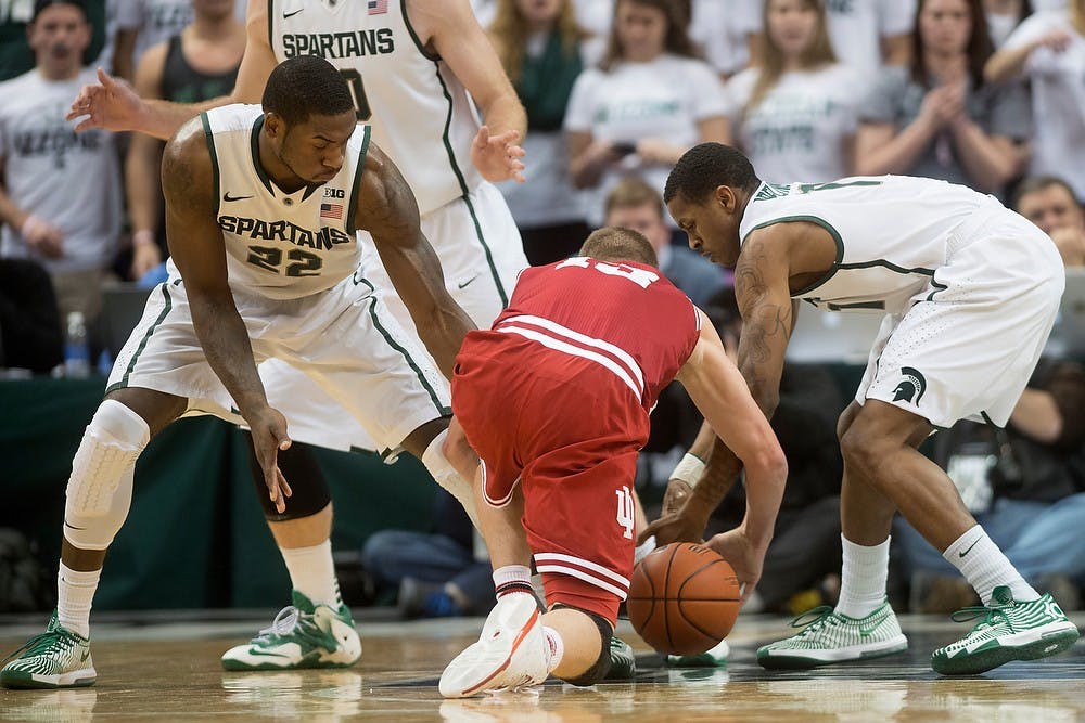 	<p>Senior guard Keith Appling, left, and junior forward Branden Dawson fight Indiana forward Austin Etherington for possession of the ball Jan. 21, 2014, at Breslin Center. The Spartans defeated the Hoosiers, 71-66. Julia Nagy/The State News</p>
