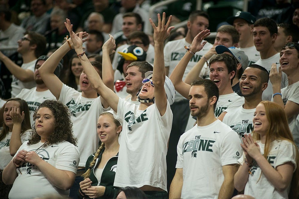 <p>Students in the Izzone cheer for the Spartans after a foul was called on Northwestern Jan. 11, 2015, during the game against Northwestern at Breslin Center. At halftime, the Spartans were tied with the Wildcats, 40-40. Erin Hampton/The State News</p>