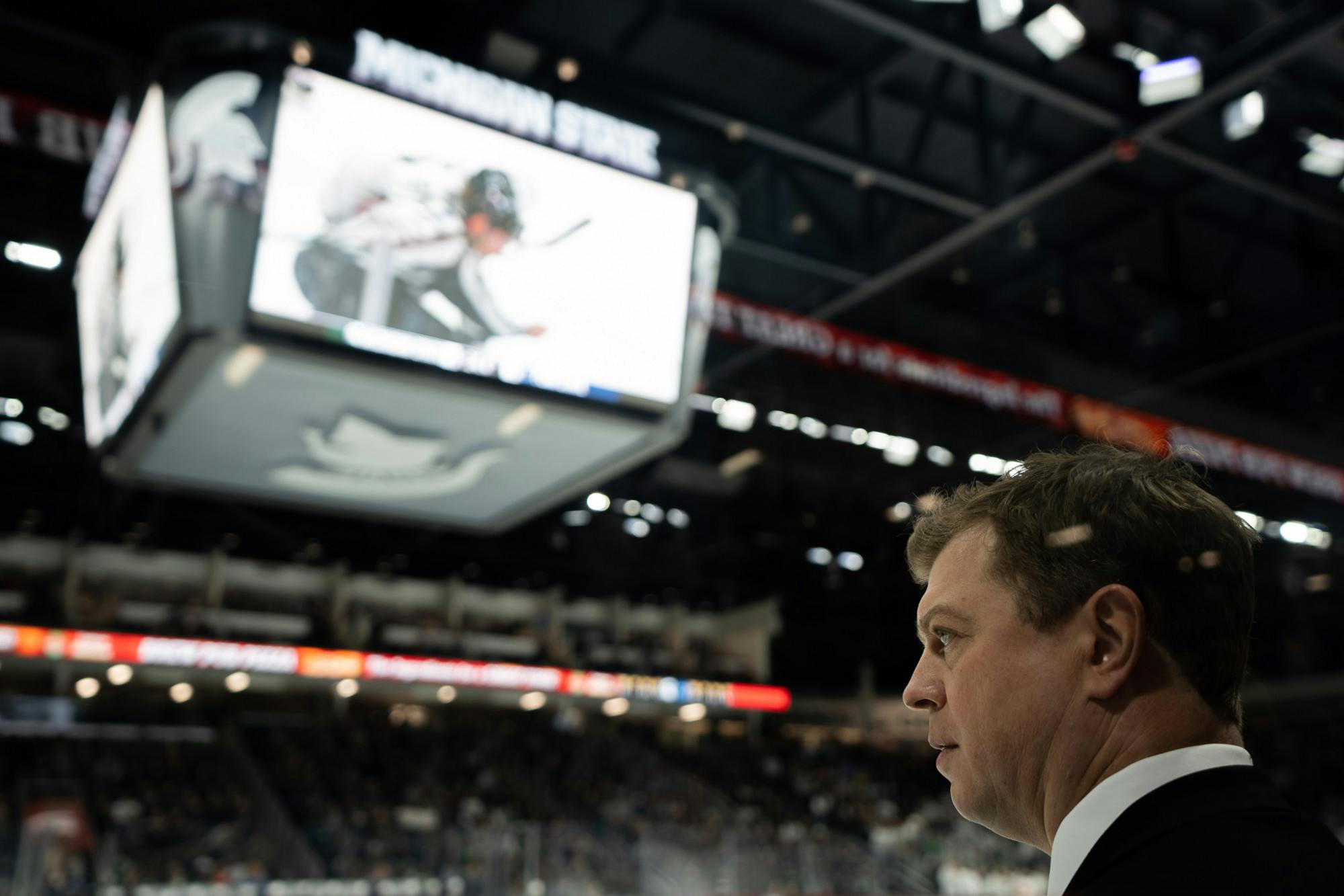 <p>MSU hockey head coach Adam Nightingale watches the game against Penn State University at Munn Ice Arena on Jan. 13, 2023. The Spartans defeated the Nittany Lions with a score of 3-2.</p>