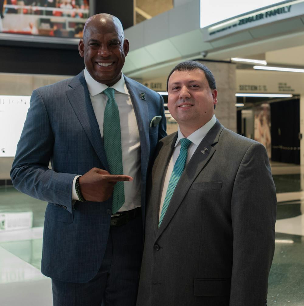 <p>Xavier DeGroat poses with head football coach Mel Tucker at the Spartan Sports Supports Autism Acceptance event on Oct. 19, 2021.</p>
