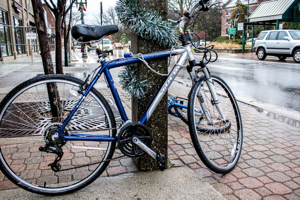 <p>Pictured is a parked bike on Nov. 21, 2017 on Grand River Ave. The recently defeated income tax proposal leaves the City of East Lansing unable to install more bike racks.&nbsp;</p>
