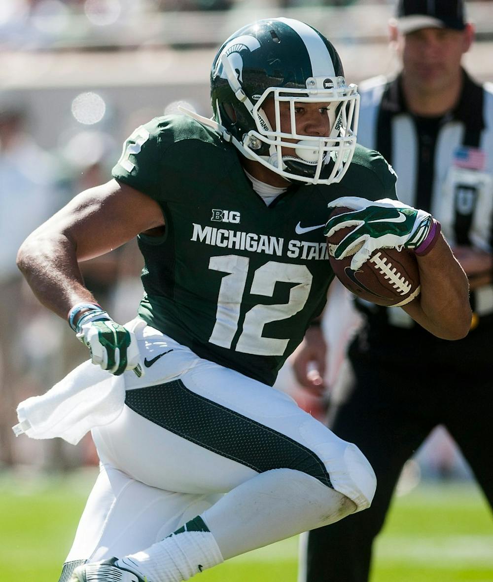 <p>Sophomore wide receiver R.J. Shelton runs the ball down the field Sept. 27, 2014, during the  game against Wyoming at Spartan Stadium. The Spartans defeated the Cowboys, 56-14. Erin Hampton/The State News</p>