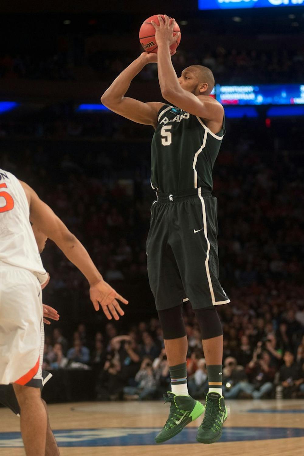 <p>Senior forward Adreian Payne shoots March 28, 2014, during the game against Virginia at Madison Square Garden in New York City during the NCAA tournament. The Spartans won, 61-59. Julia Nagy/The State News</p>