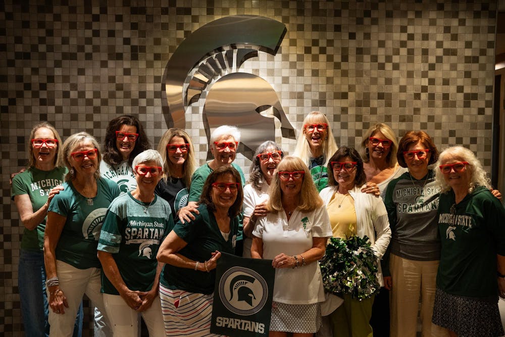 A group of Michigan State University Alumni pose for a photo at the Kellogg Center in East Lansing, Michigan, July 12, 2024. Beginning their friendship in Holden Residence Hall during the 1973-1974 school year, they decided to have a reunion at Michigan State to commemorate 50 years of friendship.