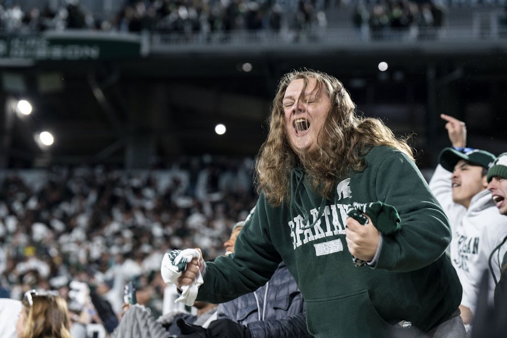 A MSU fan celebrates in the student section during the game against Wisconsin on October 15, 2022. The Spartans beat the Badgers 34 to 28.