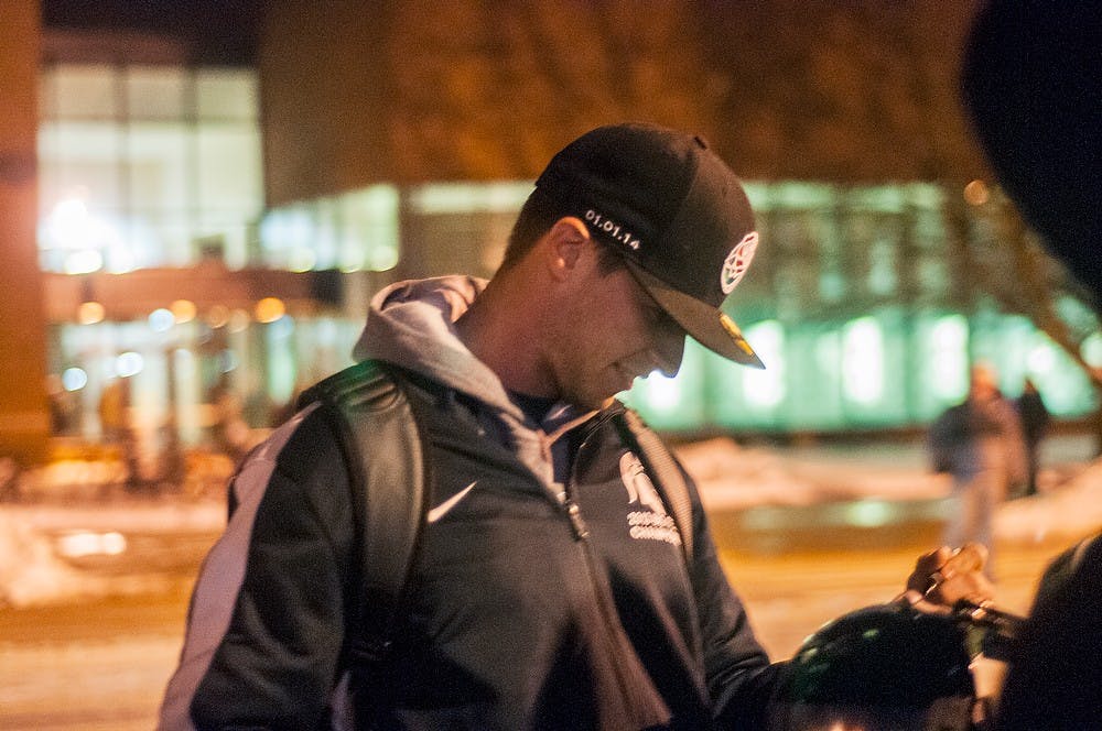 	<p>Junior punter Mike Sadler signs autographs in the Spartan Stadium parking lot after leaving Skandalaris Football Center  on Jan. 2, 2014. The team was greeted by waiting fans for the home coming following the Rose Bowl win on Jan. 1. Danyelle Morrow/The State News</p>