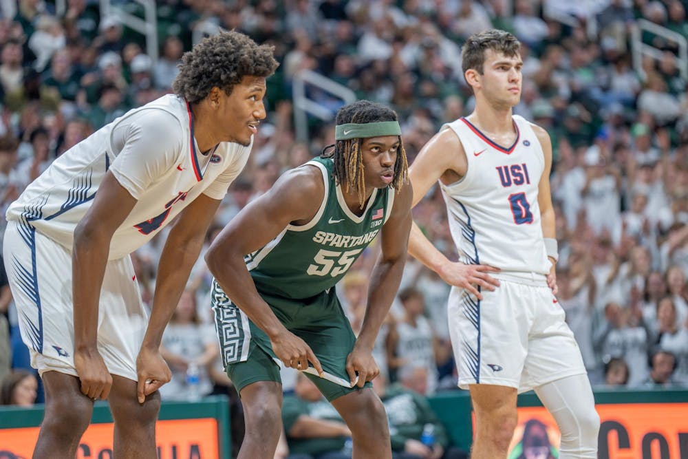 Freshman forward Coen Carr (55) while his teammate shoots a free throw during a game against Southern Indiana at the Breslin Center on Nov. 9, 2023. The Spartans defeated the Screaming Eagles 74-51. 