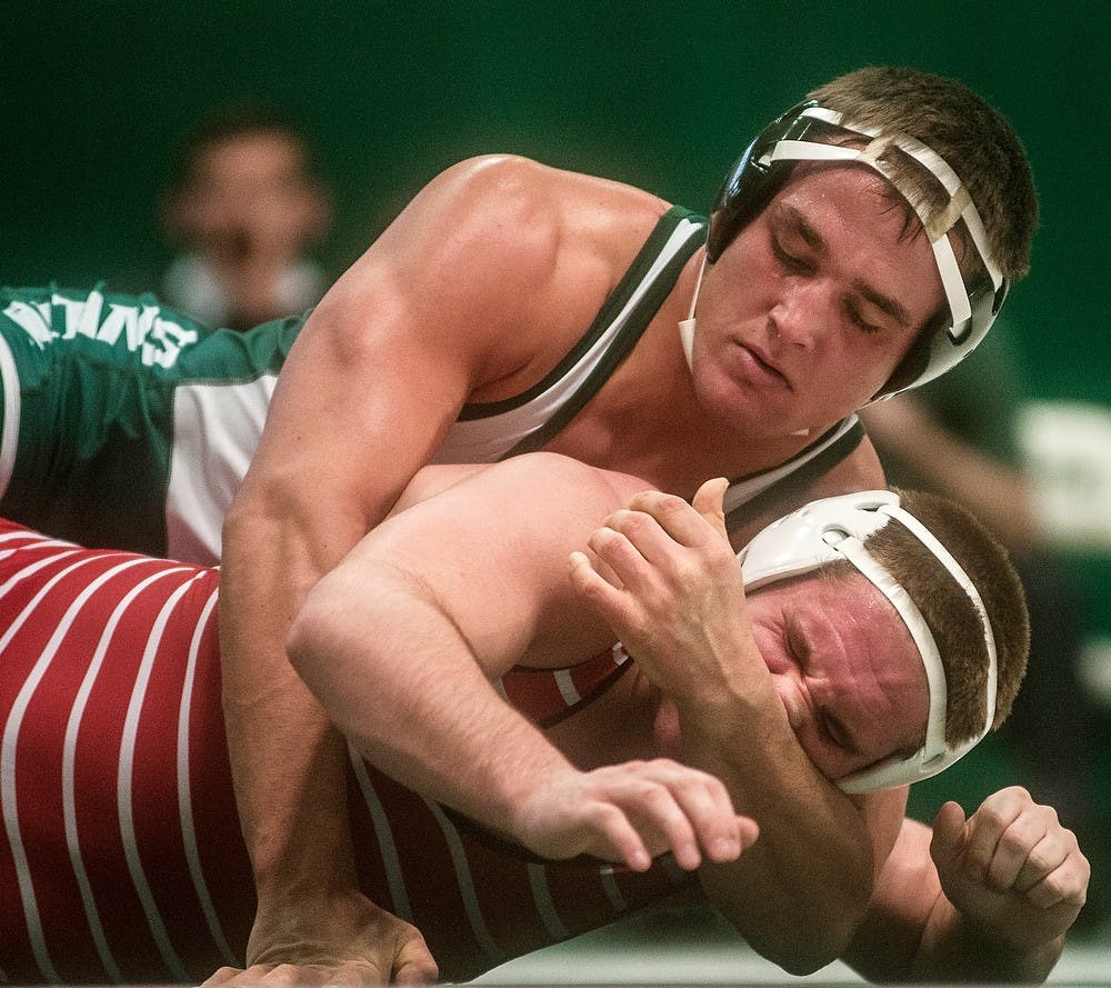 	<p>Junior 197 pounder Nick McDiarmid wrestles with Olivet wrestler Thomas Hall on Feb. 14, 2014, at Jenison Field House. The Spartans defeated the Comets, 40-0. Erin Hampton/The State News</p>