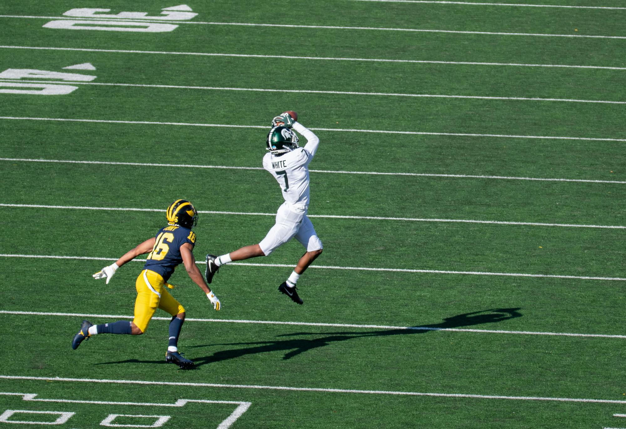 <p>Wide reciever Ricky White (7)) catches a pass from Rocky Lombardi on Oct 31, 2020 in Ann Arbor, MI.</p>