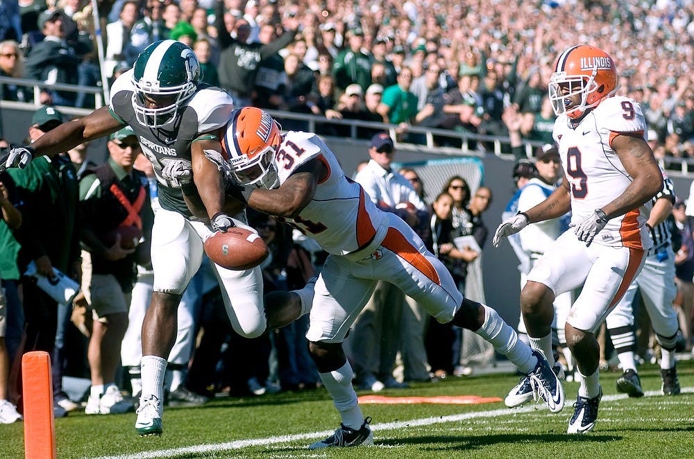 	<p>Sophomore running back Larry Caper stretches the ball across the endzone for a touchdown as Illinois defensive back Travon Bellamy, left and defensive back Trulon Henry attempt to push him out of bounds. Caper was the Spartans&#8217; leading rusher with seven carries for 38 yards and a touchdown as they went on to defeat the Fighting Illini, 26-6.</p>