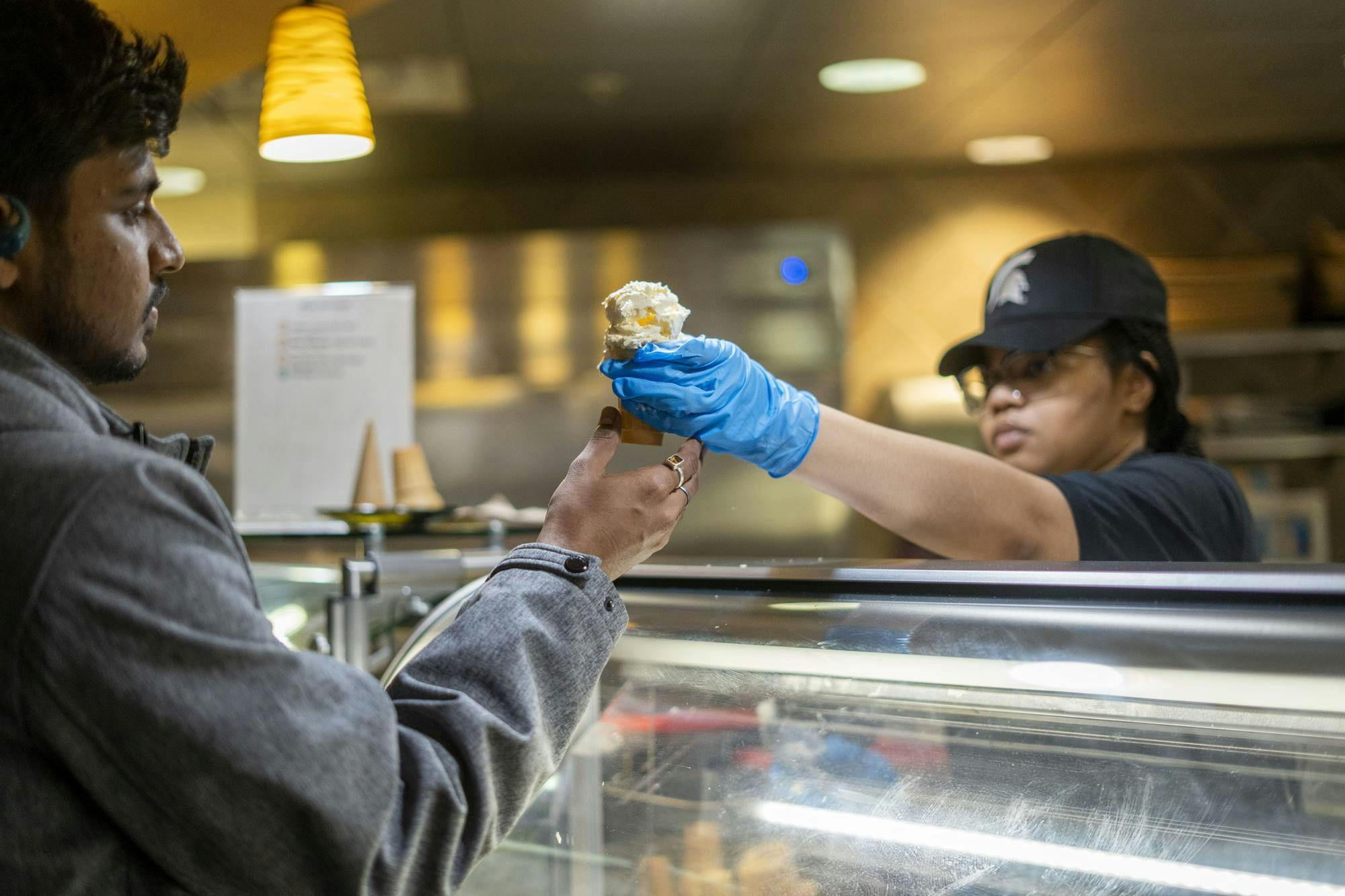 An MSU culinary services employee serves hard scooped ice cream to a customer in the Gallery dining hall on Feb. 8, 2025. The Gallery has had many recent upgrades, including the new ice cream station and a build-your-own sandwich bar. 