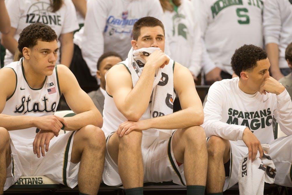 	<p>From left to right, freshman forward Gavin Schilling, junior forward Alex Gauna and junior guard Travis Trice react to the game against Michigan Jan. 25, 2014, at Breslin Center. The Spartans lost to the Wolverines, 80-75. Julia Nagy/The State News</p>