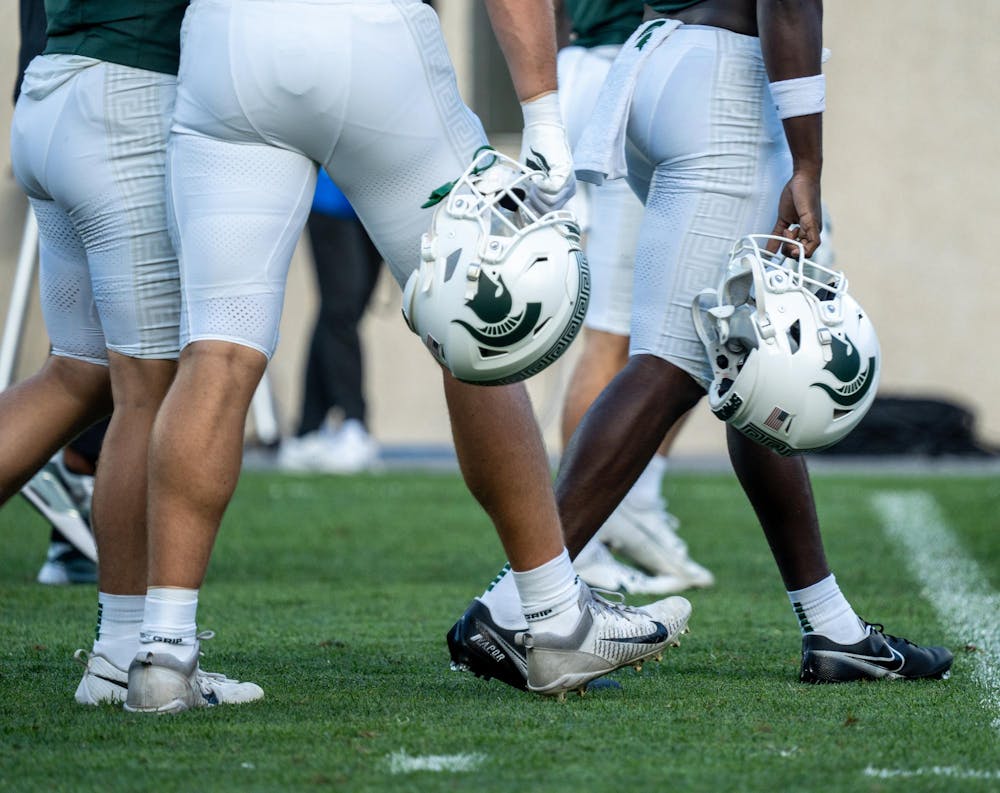 <p>MSU football players carry their helmets after the game against Richmond at Spartan Stadium on Sept. 9, 2023. The Spartans ultimately defeated the Spiders 45-14.</p>