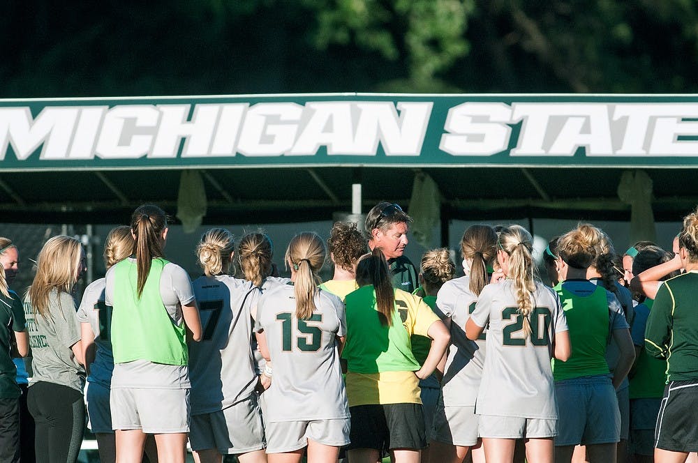 <p>Head coach Tom Saxton prepares his team for the overtime period Sept. 5, 2013, at DeMartin Stadium. The Spartans tied the Grizzlies, 1-1, after playing two scoreless overtime periods. Khoa Nguyen/ The State News</p>