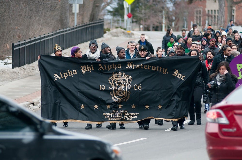 <p>Members of Alpha Phi Alpha Fraternity, Inc. led the March for Justice Jan. 19, 2015, from the MSU Union to Beaumont Tower. "Ain't gonna let segregation turn me around, turn me around, turn me around," chanted the marchers. "Ain't gonna let segregation turn me around, I'm gonna keep on walking, keep on talking, marching onto freedom land." Kelsey Feldpausch/ The State News.</p>