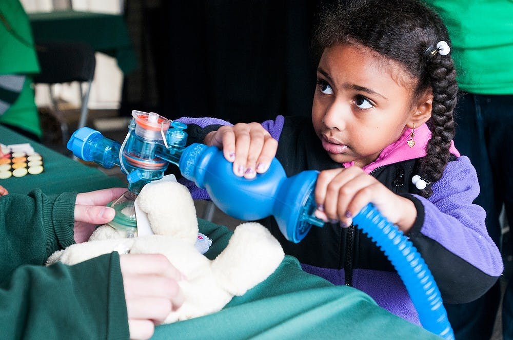 	<p>Okemos resident Zeinab Mohamed, 5, squeezes an Ambu bag during the Teddy Bear Hospital and Picnic on Saturday, Oct. 6, 2012 at the 4-H Children&#8217;s Garden. Mohamed was helping resuscitate her stuffed elephant. Julia Nagy/The State News</p>