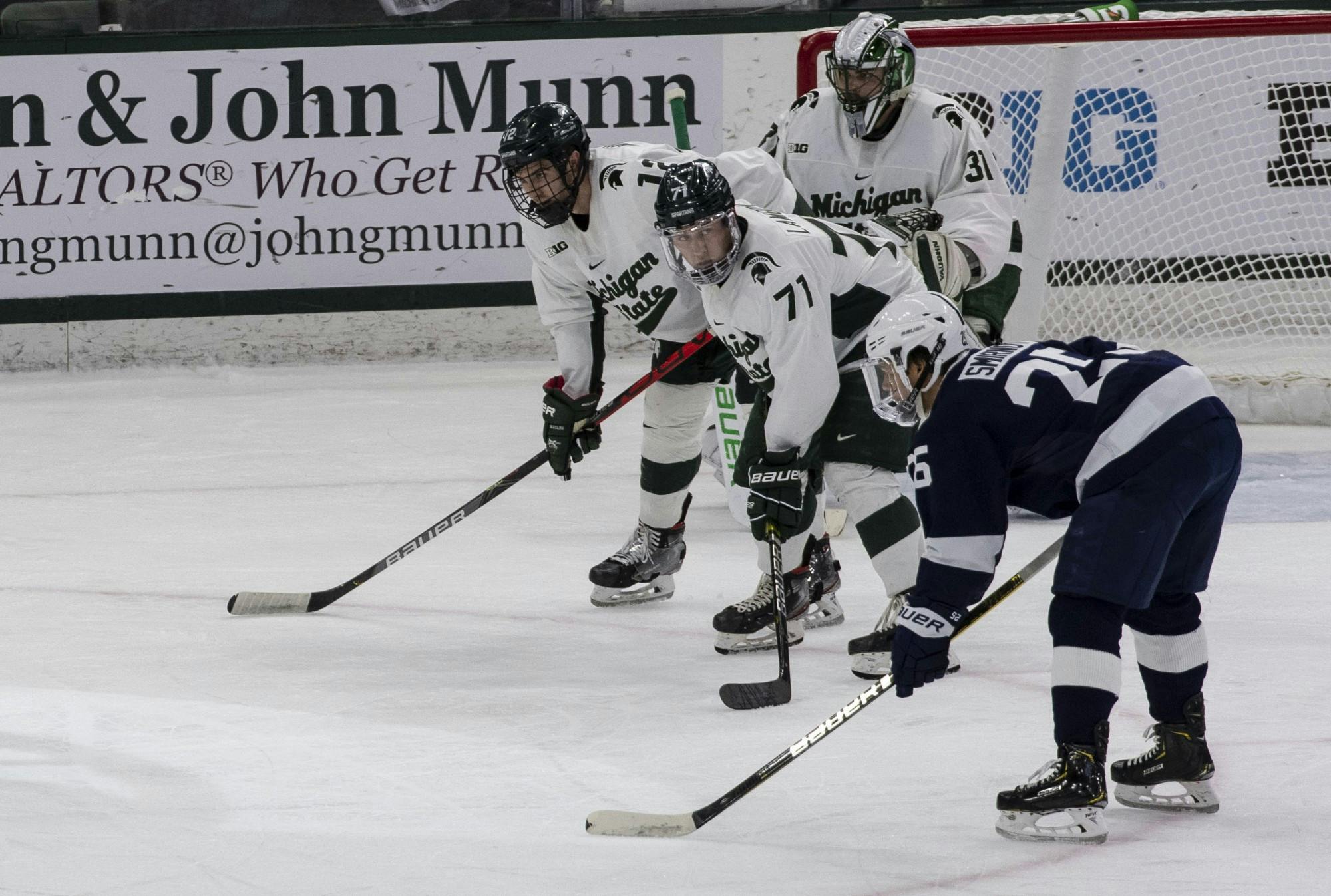 <p>Senior right wing Logan Lambdin (71), alongside his teammates, watch for the next move from Penn State as the puck is dropped. Michigan State fell to Penn State 2-1 Jan. 25, 2020.</p>