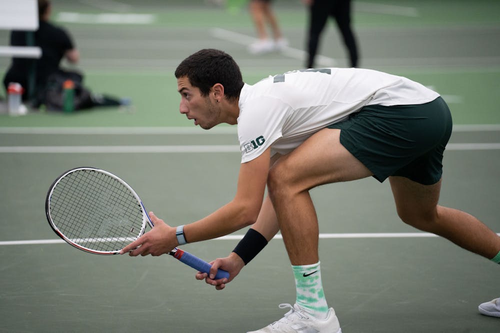 <p>Freshman Ozan Baris gets ready to return a ball near the net during his doubles match with junior Reed Crocker against Michigan at the MSU Tennis Center on March 30, 2023. The Spartans lost to the Wolverines 6-1.</p>
