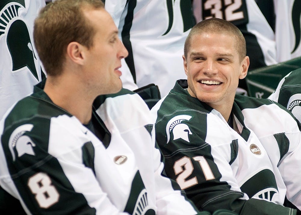 	<p>Senior forwards Chris Forfar, left, talks with Anthony Hayes on Thursday, Oct. 4, 2012 at Munn Ice Arena during a group portrait on media day. The Spartans will play their first exhibition game on Monday, Oct. 8, 2012 at home. Justin Wan/The State News</p>