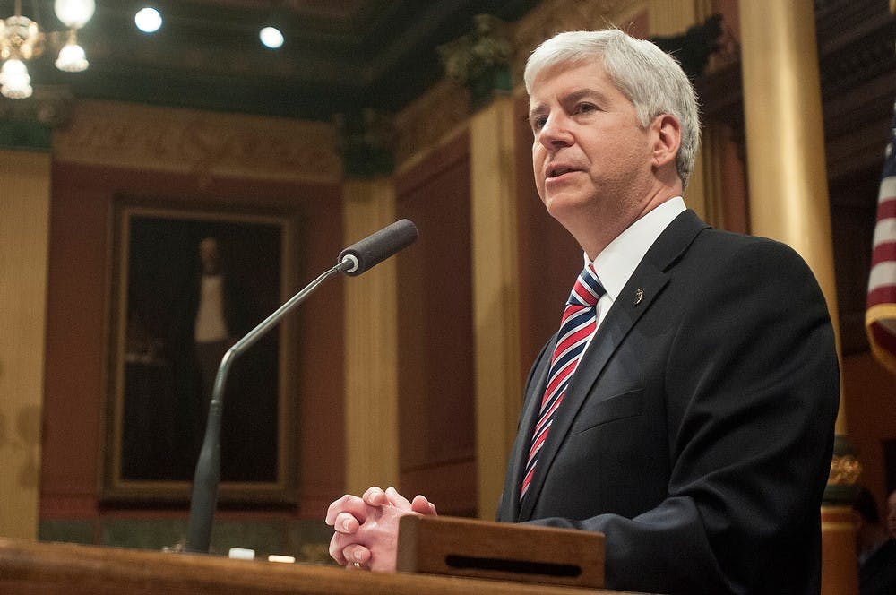 	<p>Gov. Rick Snyder gives the State of the State address Jan. 16, 2014, at the State Capitol Building in downtown Lansing. Snyder addressed education, road funding, and mental health among top issues of the state. Danyelle Morrow/The State News</p>