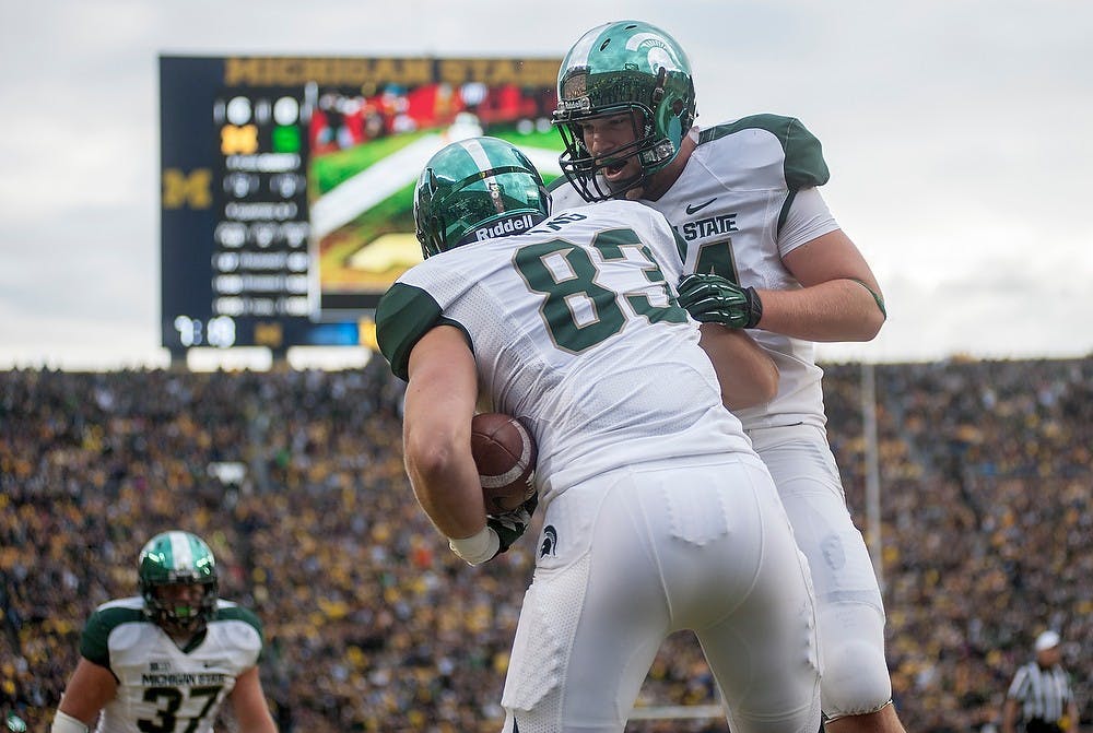 Redshirt freshman tight end Paul Lang, No. 83, celebrates with junior tight end Derek Hoebing after Lang scored a touchdown. Michigan defeated Michigan State, 12-10, on Saturday afternoon, Oct. 20, 2012, at Michigan Stadium in Ann Arbor, Mich. Justin Wan/The State News