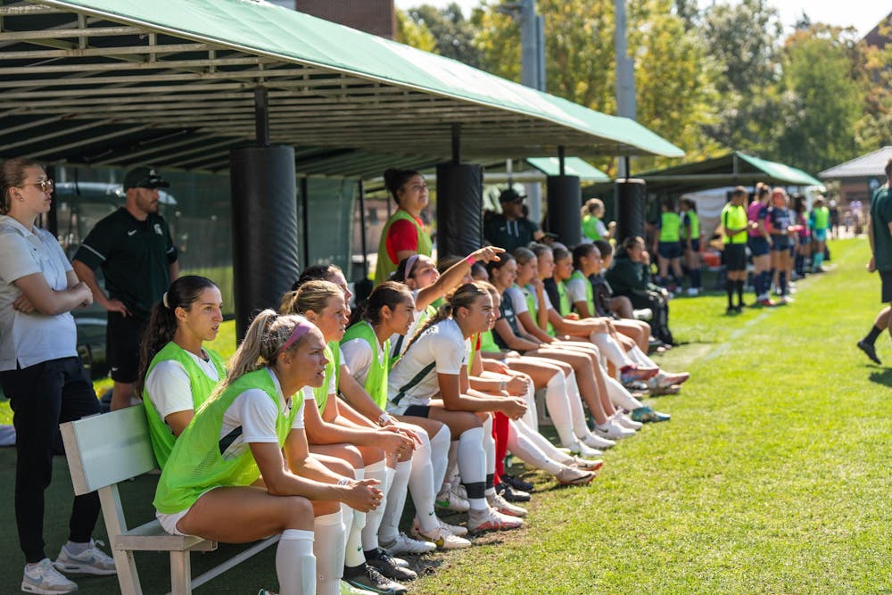 <p>The bench of the women's soccer team cheers on players at the game against Pennsylvania State University at DeMartin Soccer Stadium on Oct. 1, 2023.</p>