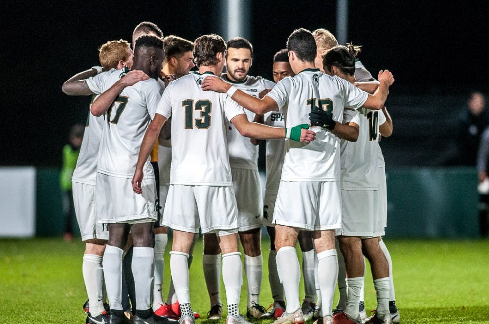 The Spartans huddle up before the game against Michigan on Oct. 23, 2018 at DeMartin Stadium. The game ended in a 1-1 tie between the Spartans and Wolverines with double overtime.