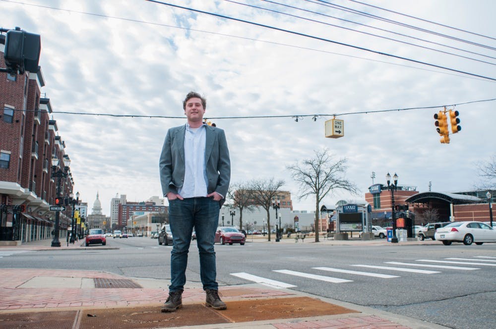 Social relations and policy senior Michael Ruddock poses for a portrait on March 23, 2017 at E. Michigan Ave in Lansing. Ruddock has been invested in politics since he was young and is running for Lansing City Council. He said there are two ways to get your name on the ballot: by paying a fee or collecting 400 signatures from registered voters in Lansing. To his knowledge, every other candidate running for the position has paid the fee, and he is the only one to have collected the signatures. "From the get go we said if we're going to run a grassroots campaign we are no going to pay a fee to get on the ballot - that's ridiculous. We're going to go talk to people at their house about issues... because people respect that," Ruddock said. 