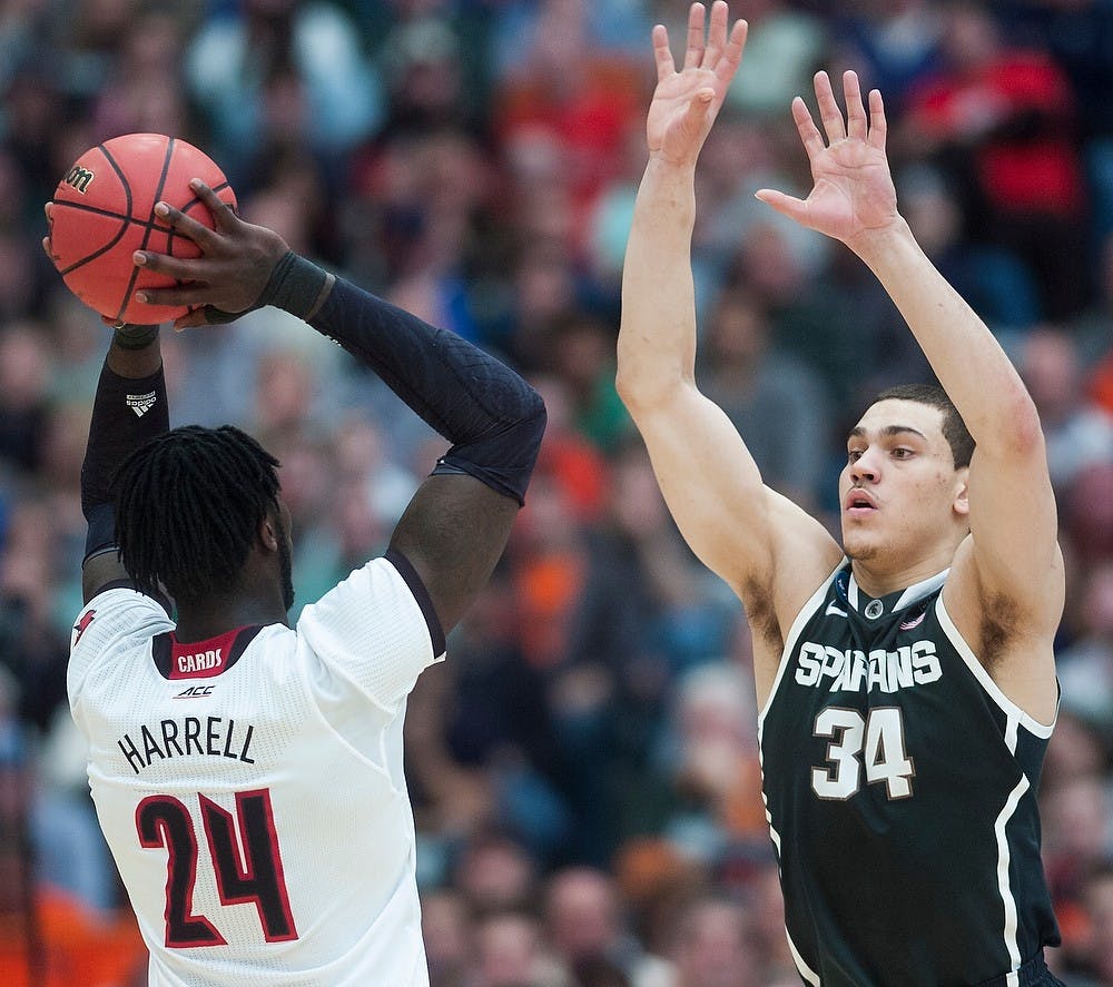 <p>Sophomore forward Gavin Schilling guards Louisville forward Montrezl Harrell March 29, 2015, during the East Regional round of the NCAA Tournament in the Elite Eight against Louisville at the Carrier Dome in Syracuse, New York. The Spartans defeated the Cardinals in overtime, 76-70. Erin Hampton/The State News</p>