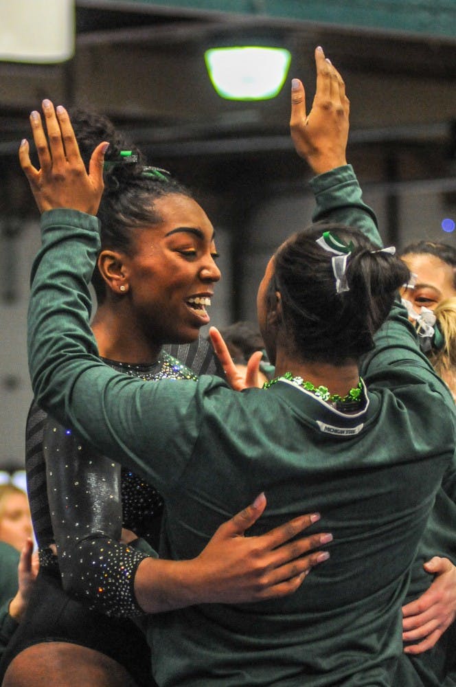 The Spartans celebrate at the women’s gymnastics meet at Jenison Field House on March 17, 2019. The Spartans placed first against Alaska, Ball State, UIC.