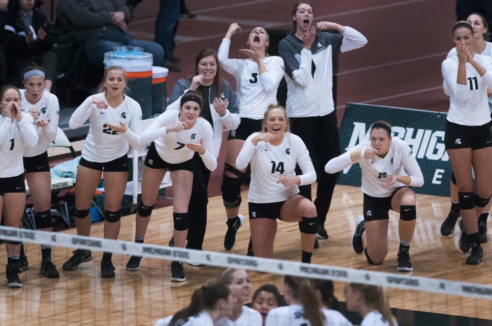 The Spartan sideline celebrates after scoring a point during the game against Arizona on Dec. 3, 2016 at Jenison Field House. The Spartans were defeated by the Wildcats, 3-2.