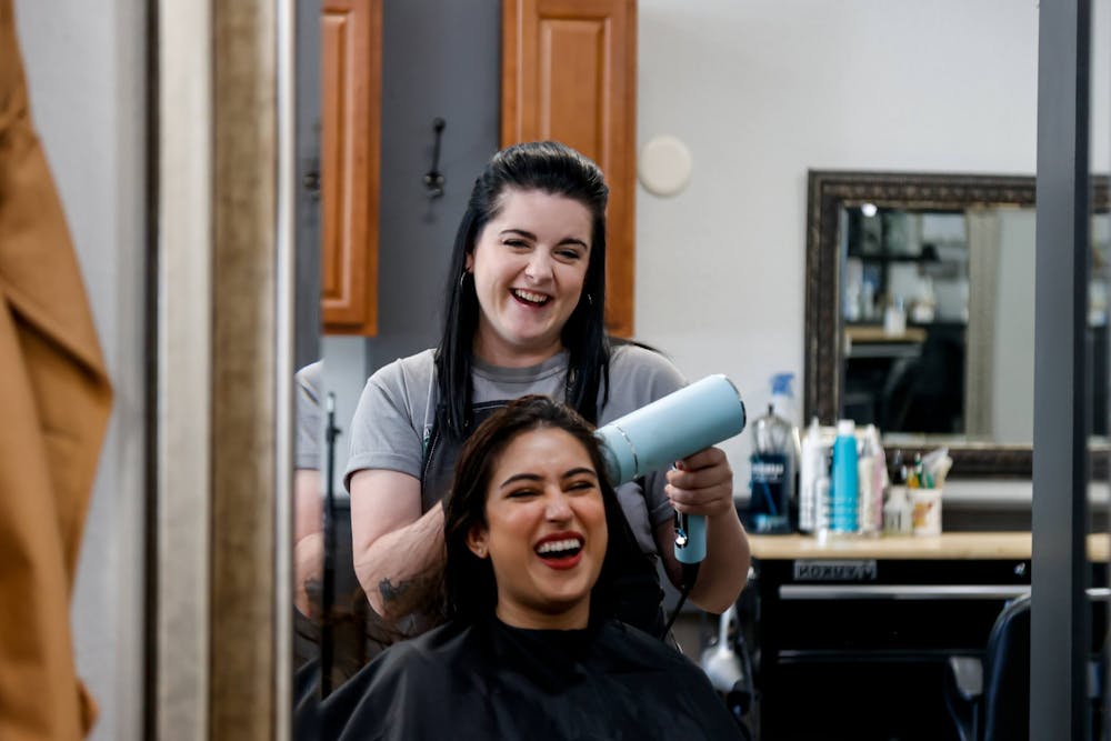 <p>Jordynn Greeson blow dries vet student Sonia Rafique’s hair on Friday, Feb. 17. Rafique got her hair done for the Michigan State University College of Veterinary Medicine’s white coat ceremony, which took place Friday night.</p>
