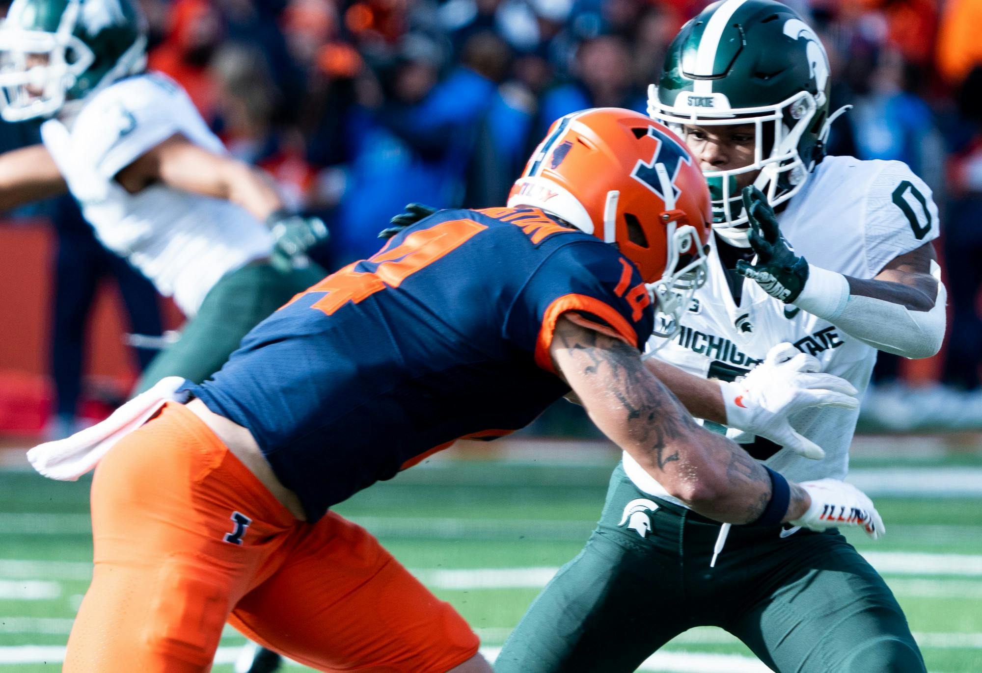 Sophomore cornerback Charles Brantley (0) fights off University of Illinois player during first half of a game at Memorial Stadium on Nov. 5, 2022. Spartans beat the Fighting Illini with a score of 23-15. 