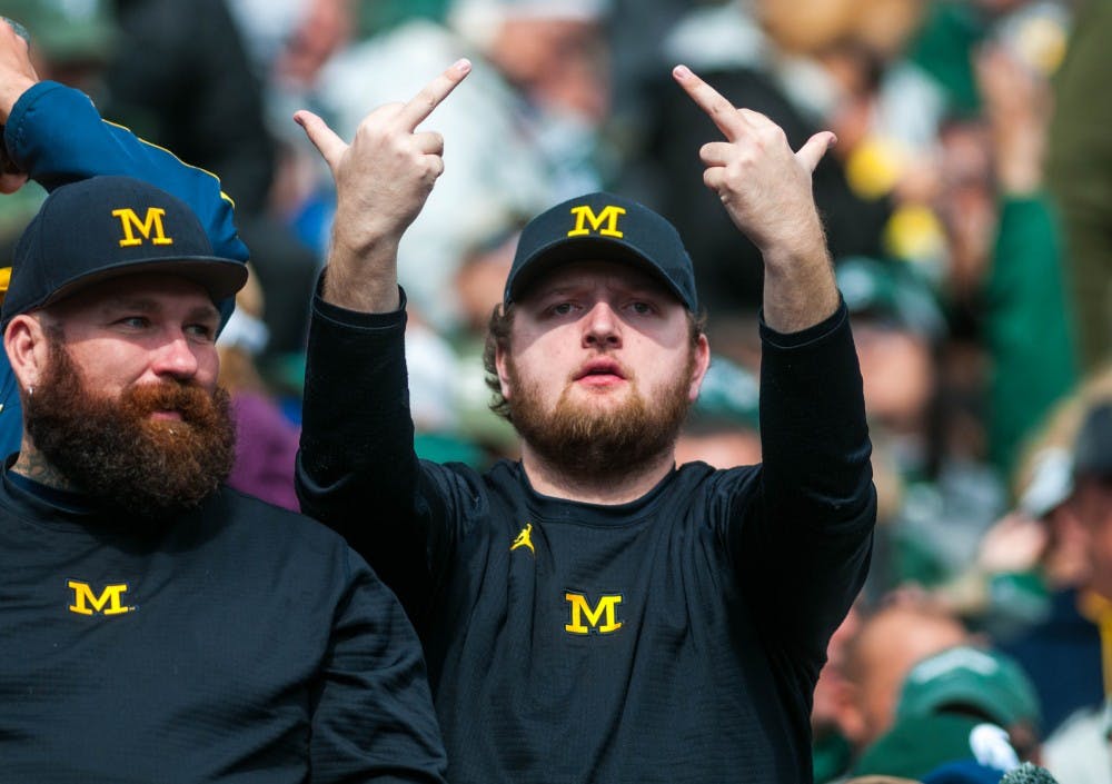 A UM fan reacts to the rain delay during the game against Michigan at Spartan Stadium on Oct. 20, 2018.