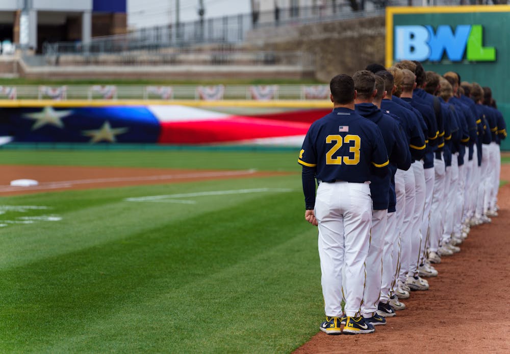 <p>Michigan gathers around for the National Anthem before their game against Michigan State. Michigan State lost 18-6 to Michigan on April 15, 2022, at the Lugnut Stadium.</p>