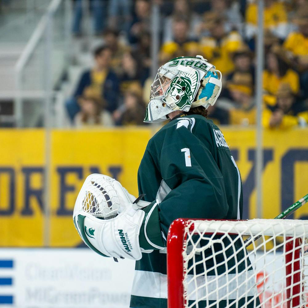 <p>Freshman goalie Trey Augustine (1) looking up at the scoreboard before a game against University of Michigan at Yost Ice Arena on Feb. 9, 2024.</p>