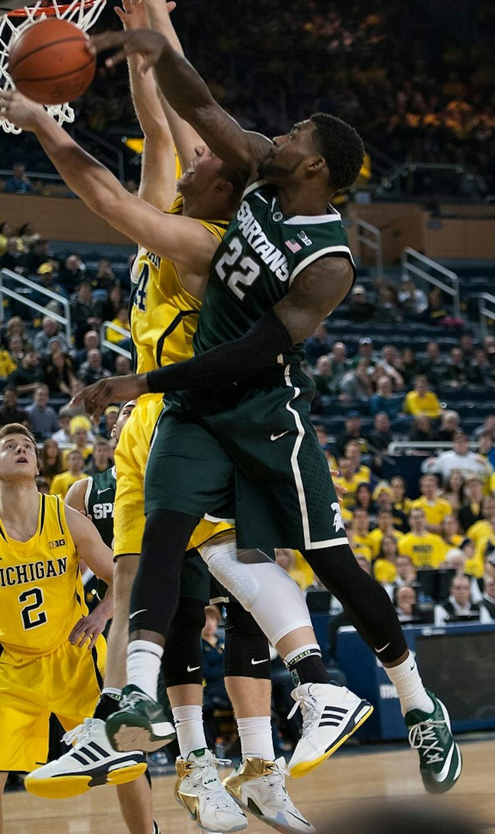 <p>Senior guard/forward Branden Dawson blocks the ball from Michigan forward Max Bielfeldt Feb. 17, 2015, during the game against Michigan at Crisler Center in Ann Arbor. The Spartans defeated the Wolverines, 80-67. Hannah Levy/The State News</p>