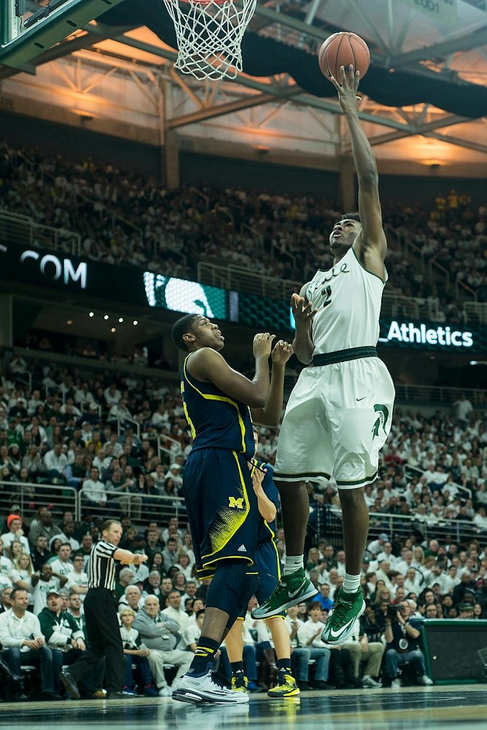 <p>Freshman forward Javon Bess attempts a point over Michigan guard forward Kameron Chatman Jan. 18, 2015, during the game against Michigan at Breslin Center. The Spartans defeated the Wolverines, 76-66. Erin Hampton/The State News</p>