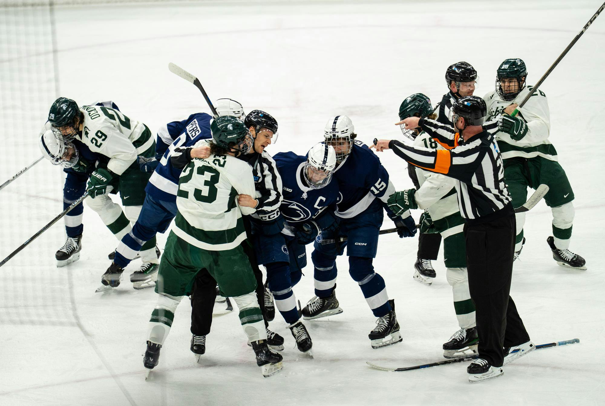<p>Referees try to break up fights between Michigan State and Penn State players at Munn Ice Arena on Feb. 22, 2025. The Spartans lost 3-2 to the Nittany Lions.</p>