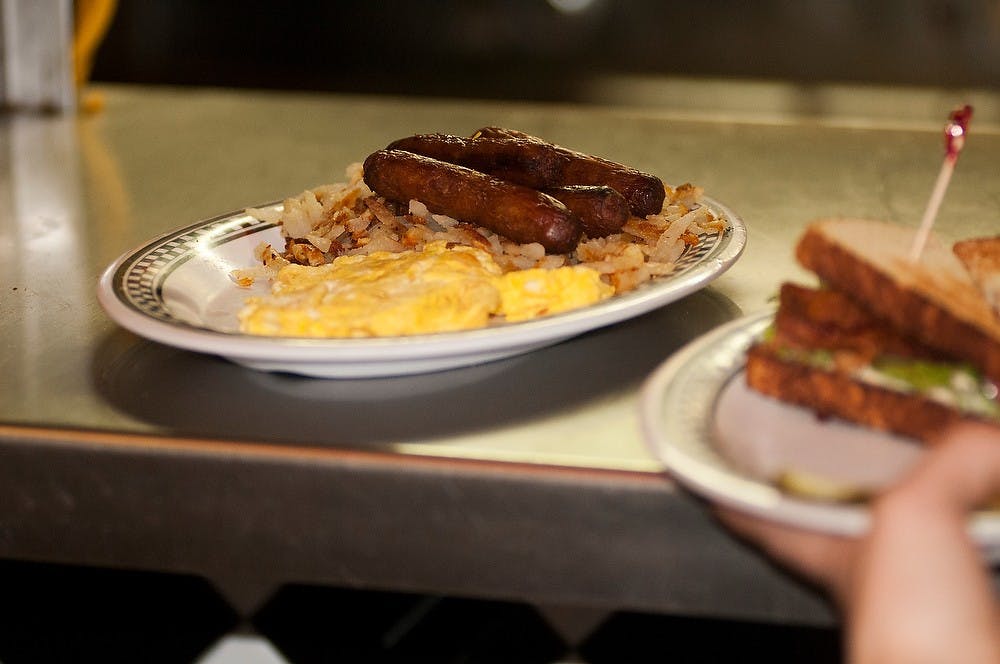 <p>Lansing resident Tenaya Martinez waits on guests Feb 18, 2015, at Fleetwood Diner, 2211 S Cedar St. in Lansing. Kennedy Thatch/The State News</p>