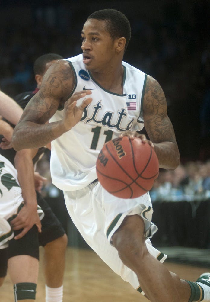 <p>Senior guard Keith Appling goes for a layup March 22, 2014, at Spokane Veterans Memorial Arena in Spokane, Wash., during their game against Harvard in the NCAA Tournament. The Spartans won, 80-73. Betsy Agosta/The State News</p>