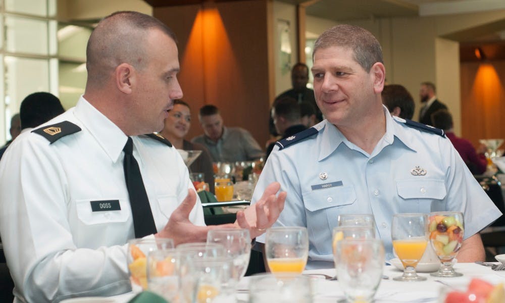 <p>Master Sgt. Wallace Doss, left, chats with Lt. Col. David Hargy on Nov. 11, 2015 during Veteran's Day Service on the fourth floor of Spartan Stadium. "This is a good stepping stone on bridging that gap and bringing more veterans out that are visible within the campus," Doss said. Veteran's Day of Service is put on by the MSU Student Veterans of America Chapter. </p>